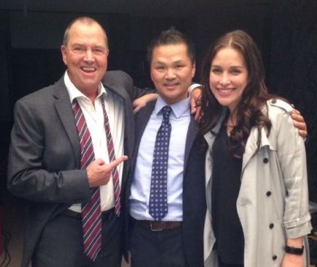 Our Master Instructor in professional attire posing with renowned stunt performers and action cinema actors.